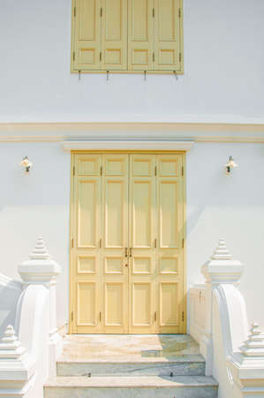 The Marble wall and yellow door and window at Wat Benchamabophit Dusitvanaram , Bangkok THAILANDの写真素材