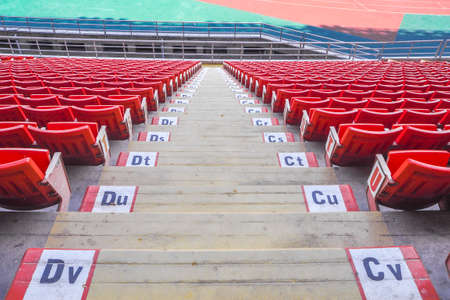 red Rows of empty seat in football stadium with stadium backgroundのeditorial素材