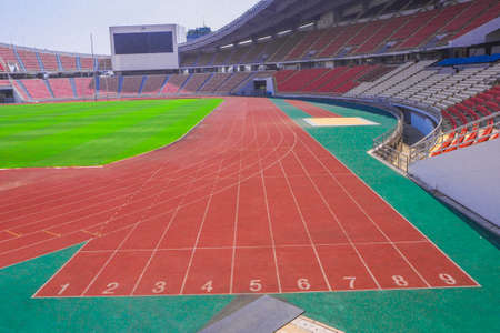 red running track field with number in the stadium backgroundのeditorial素材