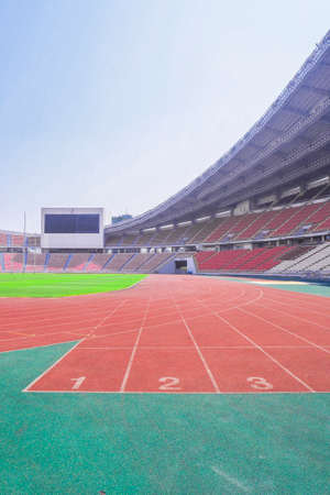 red running track field with number in the stadium backgroundのeditorial素材