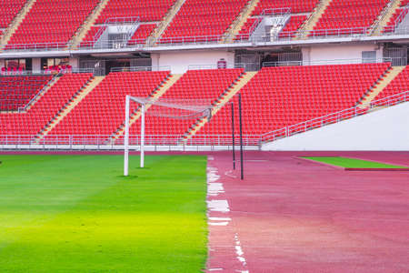 Soccer goal football on the green field inside the stadium with blue sky backgroundのeditorial素材