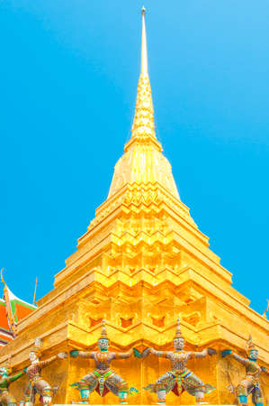 Giants under golden pagoda, Warrior statue with blue sky background at The Grand Palace and the temple Wat Phra Kaeo. Bangkok. Thailand, They are public domain or treasure of Buddhism.のeditorial素材