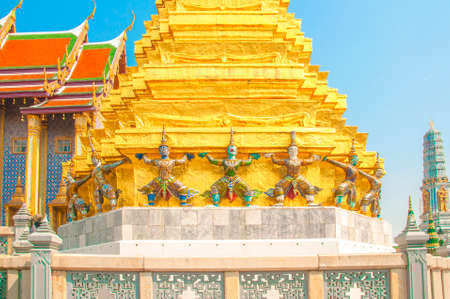 Giants under golden pagoda, Warrior statue with blue sky background at The Grand Palace and the temple Wat Phra Kaeo. Bangkok. Thailand, They are public domain or treasure of Buddhism.のeditorial素材
