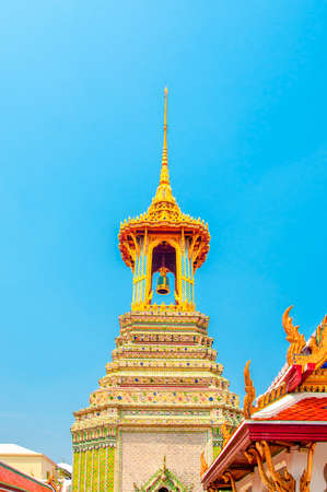 The Golden Bell Tower with Golden Temple and Blue Sky Background at Wat Phra Kaew, Bangkok, Thailand.の写真素材