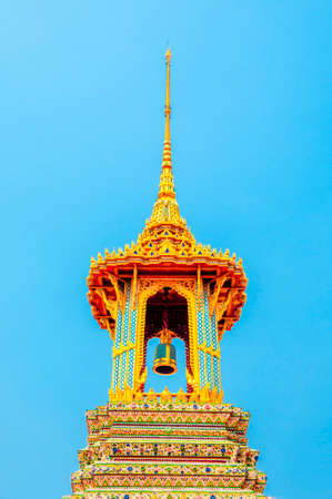The Golden Bell Tower with Golden Temple and Blue Sky Background at Wat Phra Kaew, Royal Grand Palace, Bangkok, Thailand.の写真素材
