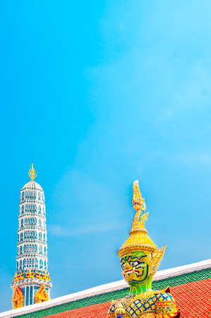 The Giant Demon Guardian with Temple and Blue Sky Background at Wat Phra Kaew, Grand Palace, Bangkok, Thailand.の写真素材