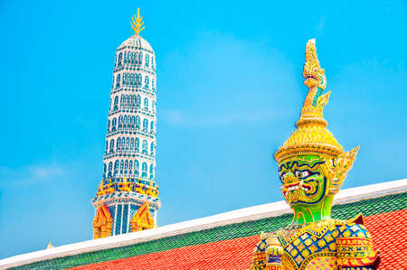 The Giant Demon Guardian with Temple and Blue Sky Background at Wat Phra Kaew, Grand Palace, Bangkok, Thailand.のeditorial素材