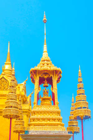 The Golden Crown and Throne with Pagoda, Temple and Blue Sky Background at Wat Phra Kaew, Grand Palace, Bangkok, Thailand.のeditorial素材
