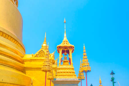 The Golden Crown and Throne with Pagoda, Temple and Blue Sky Background at Wat Phra Kaew, Grand Palace, Bangkok, Thailand.のeditorial素材
