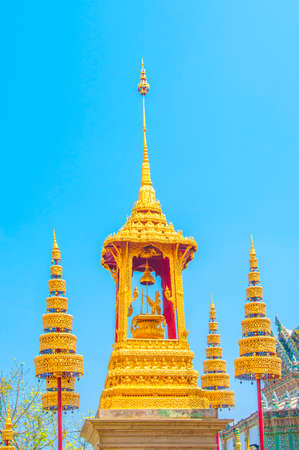 The Golden Crown and Throne with Temple and Blue Sky Background at Wat Phra Kaew, Grand Palace, Bangkok, Thailand.の写真素材