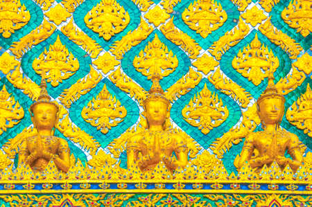The Gloden Angel and Garuda Statue with Green Thai Pattern Background At Grand palace and Wat phra keaw Bangkok Thailand.のeditorial素材