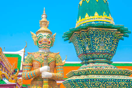 The Giant Demon Guardian with Temple and Blue Sky Background at Wat Phra Kaew,  Bangkok, Thailand.の写真素材