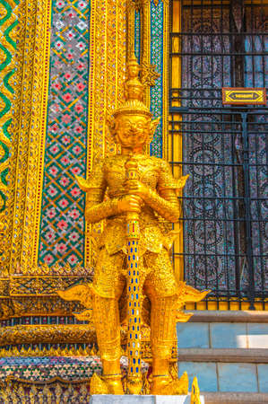 The Gloden Giant Guardian Warrior Statue with Green Thai Pattern Background At Grand palace and Wat phra keaw Bangkok Thailand.の写真素材