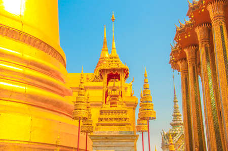 The Golden Crown and Throne with Pagoda, Temple and Blue Sky Background at Wat Phra Kaew, Grand Palace, Bangkok, Thailand.のeditorial素材