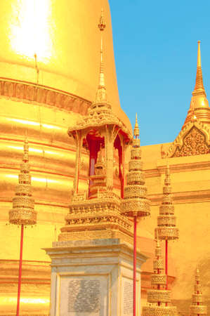 The Golden Crown and Throne with Pagoda, Temple and Blue Sky Background at Wat Phra Kaew, Grand Palace, Bangkok, Thailand.のeditorial素材