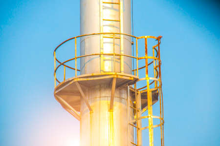 Close up Industrial view of pipelines at oil refinery plant form industry zone with blue sky and sunrise sky backgroundの写真素材