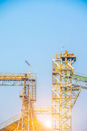 Industrial view at oil refinery plant form industry zone with blue sky and sunrise sky backgroundの写真素材