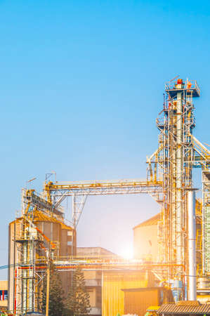 Industrial view at oil refinery plant form industry zone with blue sky and sunrise sky backgroundの写真素材