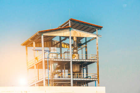 Industrial view of pipelines and valves  at oil refinery plant form industry zone with blue sky and sunrise sky backgroundの写真素材