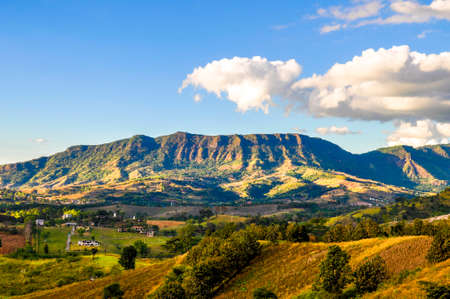 summer mountains green grass landscape with blue sky backgroundの写真素材