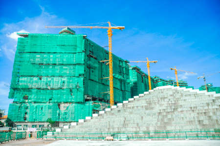 Crane and building construction site with  blue sky backgroundの写真素材