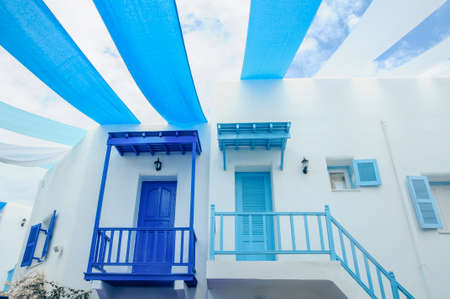 Cityscape of the village of Oia town on Santorini island, Greece. Traditional and famous houses and churches with blue domes over the Caldera, Aegean seaのeditorial素材