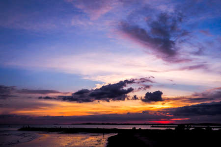 Fantastic view of the dark overcast sky. Dramatic and picturesque twilight scene with blue, purple and yellow sky backgroundの写真素材