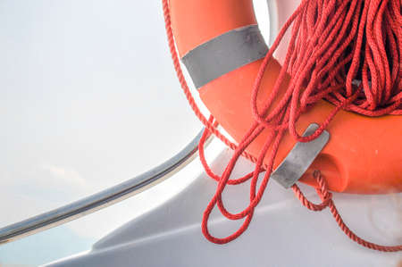 Ring life boy on big boat.Obligatory ship equipment.Personal flotation device.Prevent drowning.Orange lifesaver on the deck of a cruise ship.Traveling to an islandの写真素材