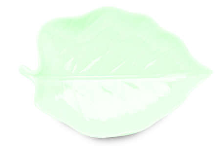 Empty green leaf shape  ceramics plate isolated on white background with clipping path.の写真素材