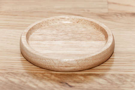 Empty wooden plate with the soft wood background. can be use for kitchen concept.の写真素材