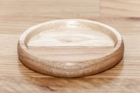 Empty wooden plate with the soft wood background. can be use for kitchen concept.の写真素材