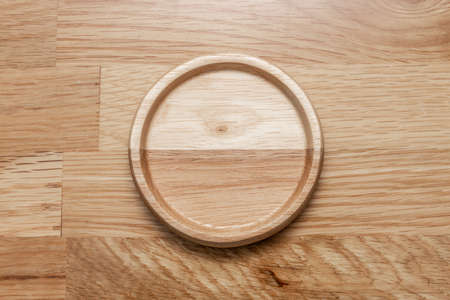 Empty wooden plate with the soft wood background. can be use for kitchen concept.の写真素材