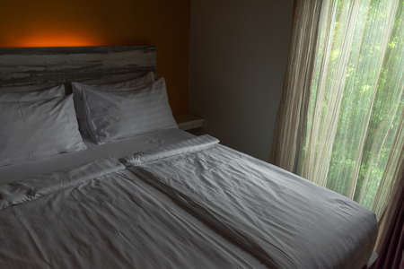 Close up Interior of white cozy bedroom in modern design.の写真素材