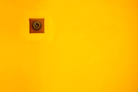 Switch light on a yellow wall.の写真素材