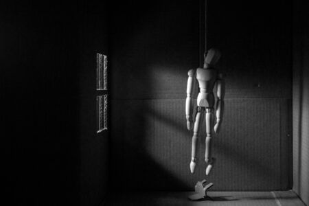 Wooden puppet hangedの写真素材