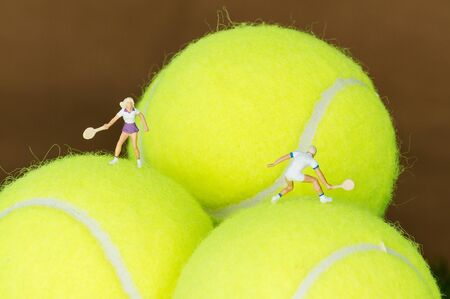 Tiny toy tennis player on a tennis ball.の写真素材