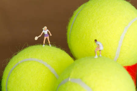 Tiny toy tennis player on a tennis ball.の写真素材