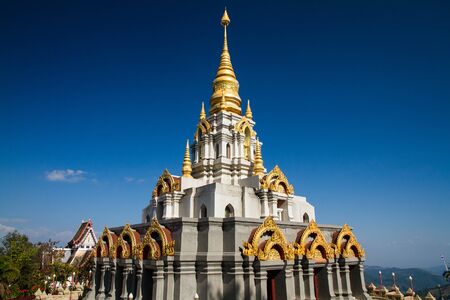 Golden pagoda with blue sky in the north of Thailand.の写真素材