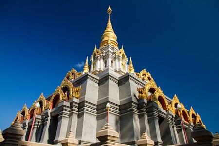 Golden pagoda with blue sky in the north of Thailand.の写真素材