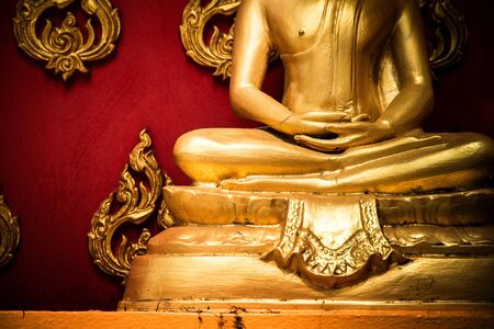 Golden Buddha sitting in meditationの写真素材