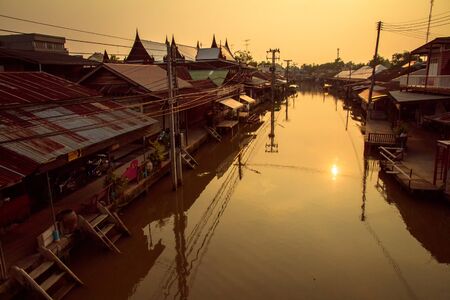 House on a canal in the evening  thailandの写真素材