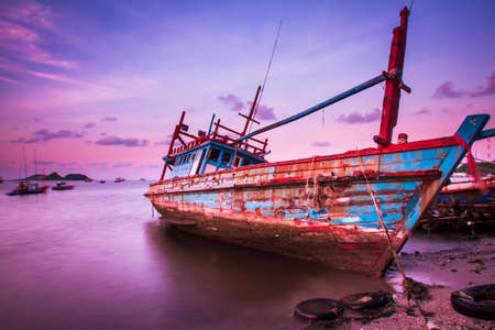 Large fishing boats beached at low tideの写真素材
