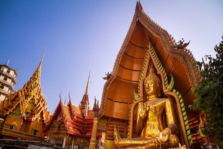 The largest golden Buddha with blue sky as a backdropの写真素材