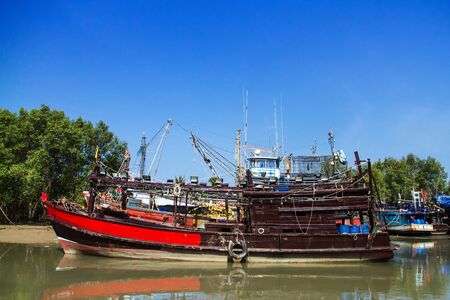Fishing boats dock at low tideの写真素材