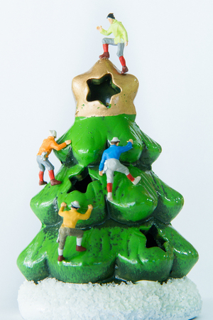 Tiny toys climbing on the Christmas treeの写真素材