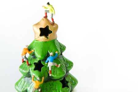 Tiny toys climbing on the Christmas treeの写真素材