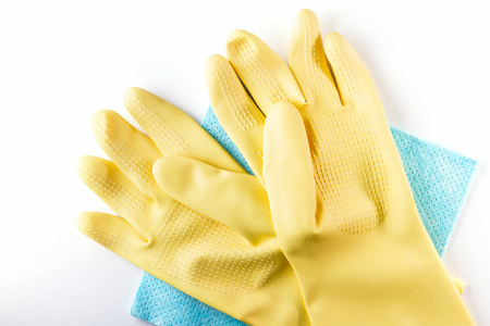 Yellow rubber gloves lay on blue cleaning napkinsの写真素材