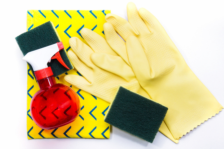Yellow rubber gloves and scrubber sponges on yellow cleaning napkinsの写真素材