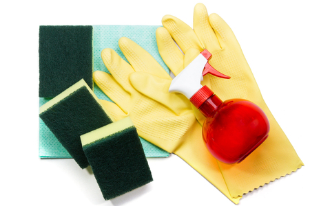 Yellow rubber gloves and scrubber sponges on blue cleaning napkinsの写真素材