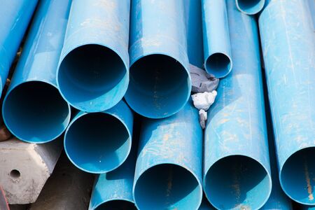 PVC pipes stacked in construction site.